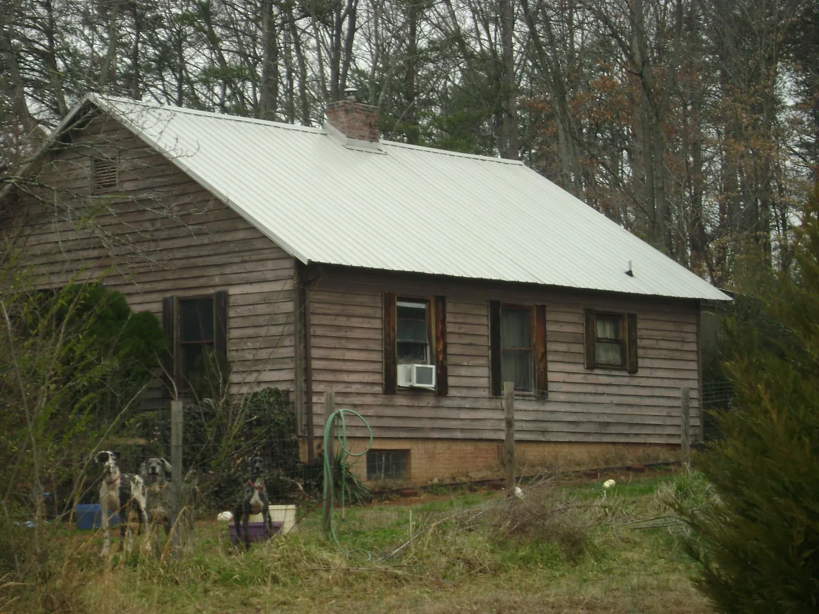 White metal roof on an old wood sided farmhouse, from a Metal Roof Installation job in Columbia Cross Roads
